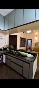 a kitchen with a counter top with vegetables on it at Cherry guest House Shringeri ,koppa rural in Chikmagalur