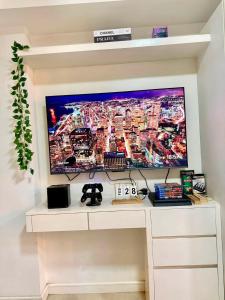 a tv on a wall in a living room at Affordable Staycation at Azure Urban Resort Residences Near NAIA in Manila