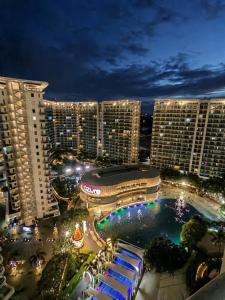 a view of a city at night with tall buildings at Affordable Staycation at Azure Urban Resort Residences Near NAIA in Manila