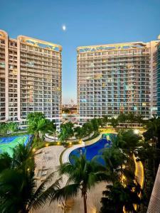 a view of a resort with palm trees and buildings at Affordable Staycation at Azure Urban Resort Residences Near NAIA in Manila