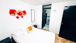 a bedroom with a bed and a heart on the wall at Hotel Beijing Cartagena in Cartagena de Indias +11 photos