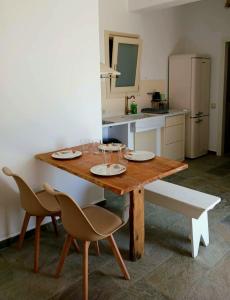 ein Holztisch in einer Küche mit zwei Stühlen und einem Tisch sidx sidx sidx in der Unterkunft Alchemis in Kardhianí