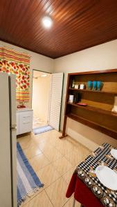 a kitchen with a table and a refrigerator in a room at Cantinho aconchego 2 in Naviraí