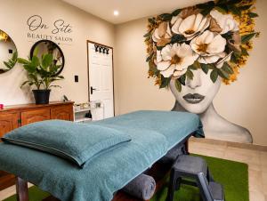 a room with a bed with a flower head on the wall at Joy Haven - Open Plan Studio in Centurion