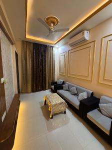 a living room with a couch and a table at Sunita Kunj in Jhūsi