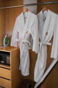 a group of white robes hanging on a rack at Ming Garden Hotel in Kota Kinabalu +67 photos