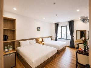 a hotel room with two beds and a desk at Laimeront Hotel Dalat Vietnam in Da Lat +74 photos