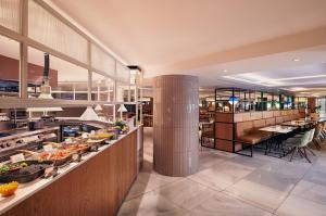 a restaurant with a buffet line with food at Meliá White House in London