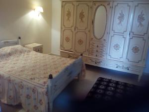 a bedroom with a bed and a large dresser at Dari in El Haouaria