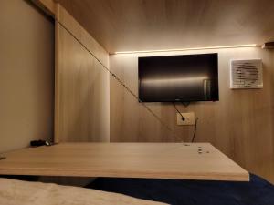 a flat screen tv on a wall in a room at Casa Tayrona Suites in Medellín