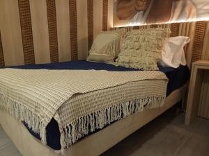 a bed with pillows on it in a bedroom at Casa Tayrona Suites in Medellín +16 photos