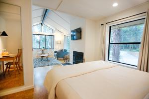 a bedroom with a bed and a large window at SCP Mendocino Inn and Farm in Little River