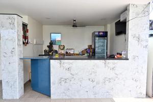 a kitchen with a counter and a gas station at Hotel Siddveer Grand in Guntūr +14 photos