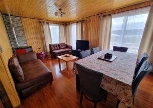 a living room with a table and a couch at Cabañas Chiloé in Dalcahue