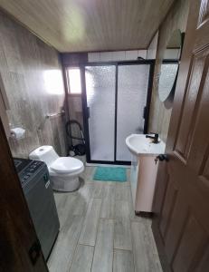 a small bathroom with a toilet and a sink at Cabañas Chiloé in Dalcahue +10 photos