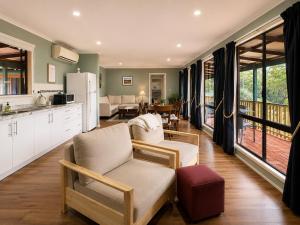 a kitchen and living room with a couch and a table at Pecan Hill BNB in Toodyay