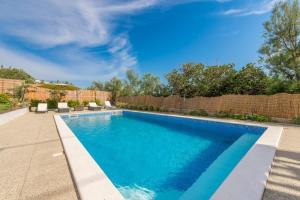 a swimming pool in the backyard of a home at My Dalmatia - Apartment Nostromo in Pag