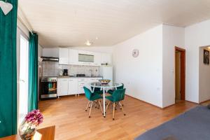 a kitchen with a table and chairs in a room at My Dalmatia - Apartment Nostromo in Pag