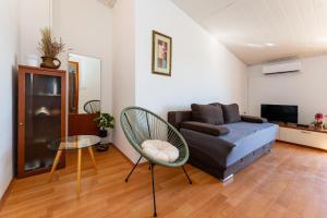 a living room with a couch and a chair at My Dalmatia - Apartment Nostromo in Pag