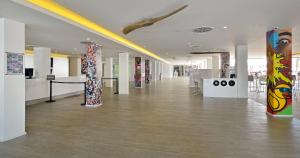 a hallway with paintings on display in a building at SOL by Meliá House Mallorca - Adults Only in Magaluf