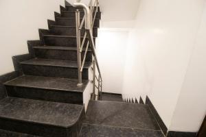 a staircase in a building with black and white at Hotel O Sai Plaza in Aurangabad