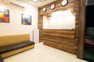 a room with a wooden door with clocks on the wall at Hotel O Sai Plaza in Aurangabad