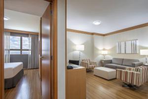 a hotel room with a bed and a couch at Hotel Brasil 21 Convention, Affiliated by Meliá in Brasília