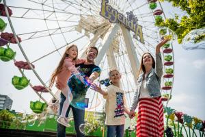 a group of people standing in front of a ferris wheel at Apartamenty Katowice by Lantier - Basen & Gabinet SPA in Bytom