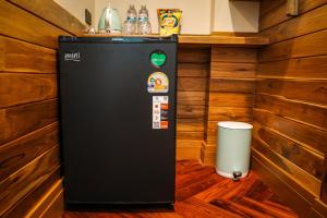 a drink machine in a room with wooden walls at Salty Pearl Beach Front Phuket in Patong Beach