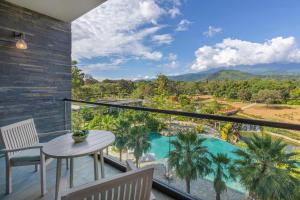 a balcony with a table and a view of a pool at Gran Meliá Arusha in Arusha