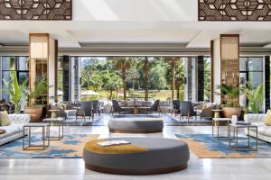 a lobby with couches and tables and chairs at Gran Meliá Arusha in Arusha