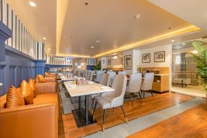 a dining room with a table and chairs at Saltstayz Premier - Noida Sector 15 in Noida