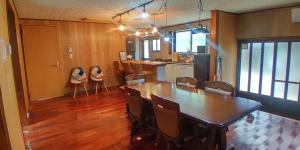 a kitchen and dining room with a table and chairs at 神乃宿 in Shimonoseki