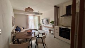 a kitchen and a living room with a table and chairs at Sigma Exotic Palio Beach Apartment in Paleo Tsifliki +20 photos