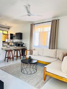 a living room with a couch and a table at Ntate Homes, Diani Near the Beach in Diani Beach