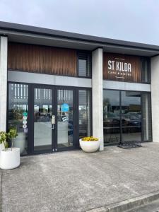 a store front with glass doors and flowers in front at # 2 Ald in Cambridge +2 photos