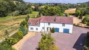 an aerial view of a white house with blue doors at Lower Tundridge Cottage in Suckley