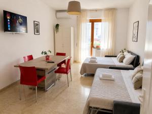a living room with a bed and a table and chairs at Carducci Mare e Monti in Pescara