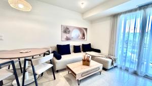 a living room with a couch and a table at Sigma Exotic Palio Beach Apartment in Paleo Tsifliki