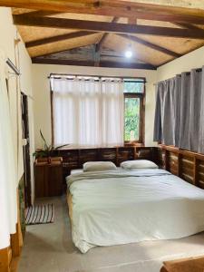 a bedroom with a large bed and a window at Banana garden in Pai