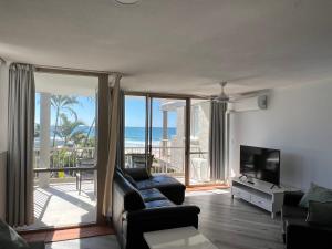 a living room with a view of the ocean at Sanctuary Beach Resort in Gold Coast