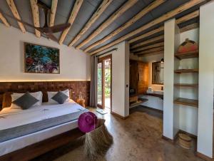 a bedroom with a large bed and a bathroom at Bamboo Zanzibar in Jambiani +95 photos