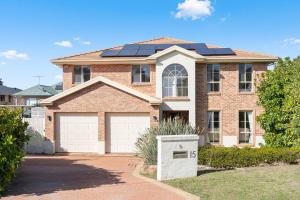 a house with solar panels on the roof at Drumbern Pool House Macquarie Links in Ingleburn