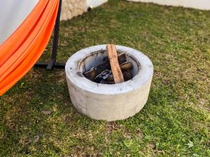 a fire pit with a stick in a tire at Hanara Bohemian Villa in Bandung