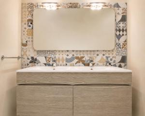 a bathroom with a sink and a mirror at Carducci Mare e Monti in Pescara