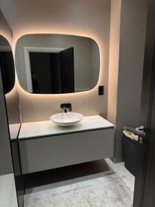 a bathroom with a white sink and a mirror at The Apse in Stotfold +17 photos