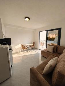 a living room with a couch and a table at Azur Apartments Bar in Bar +50 photos