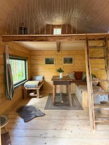 a log cabin with a bunk bed and a table at Glamping Olivia v lese in Radíč