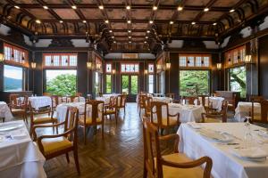 a dining room with white tables and chairs at The Fujiya Hotel in Hakone