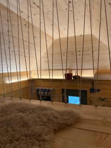a room with a wooden ceiling and a rug at Glamping Olivia v lese in Radíč